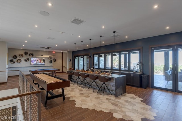 4290 Solace St, Las Vegas, NV 89135 - rec room with billiards, bar with sink, wood finished floors, french doors, and recessed lighting
