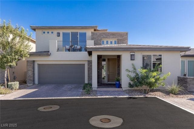 4290 Solace St, Las Vegas, NV 89135 - view of front of home featuring a balcony, stucco siding, an attached garage, and driveway