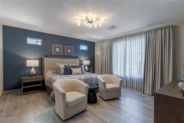 4290 Solace St, Las Vegas, NV 89135 - bedroom with a chandelier and an accent wall