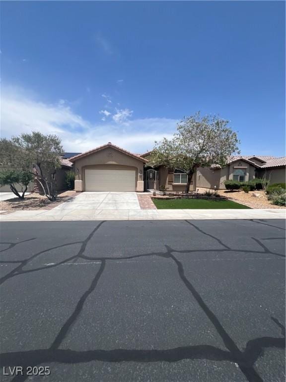 6092 Fox Creek Ave, Las Vegas, NV 89122 - view of front of house with a garage, stucco siding, concrete driveway, and a tiled roof