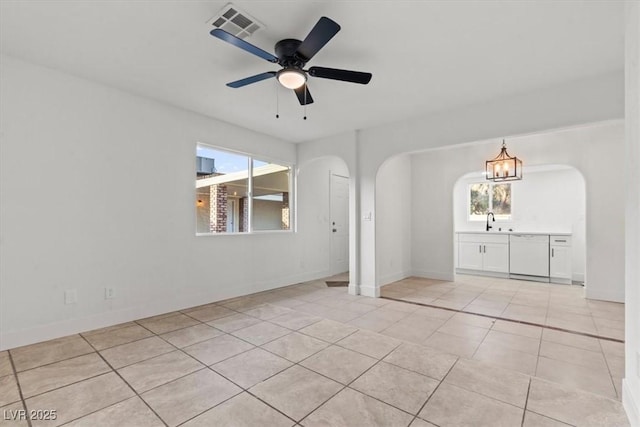 4805 Jay Ave, Las Vegas, NV 89130 - spare room featuring arched walkways, plenty of natural light, light tile patterned flooring, and a sink