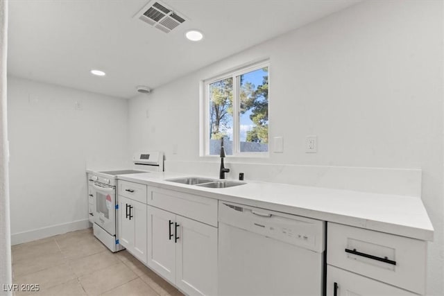 4805 Jay Ave, Las Vegas, NV 89130 - kitchen with white appliances, a sink, white cabinets, light countertops, and light tile patterned floors