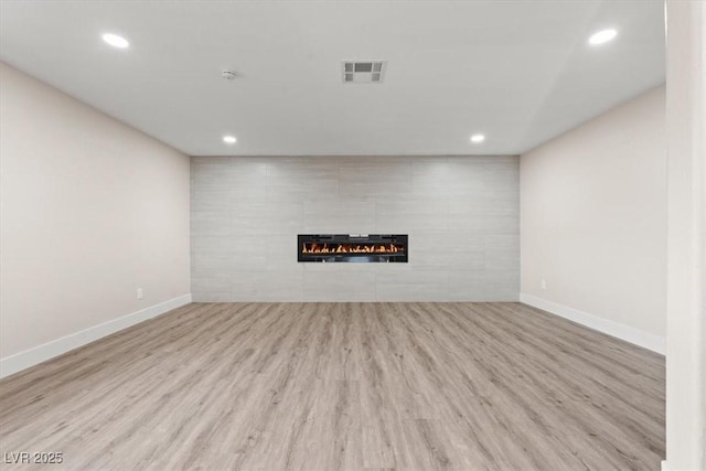 4805 Jay Ave, Las Vegas, NV 89130 - unfurnished living room with recessed lighting, baseboards, a tile fireplace, and wood finished floors