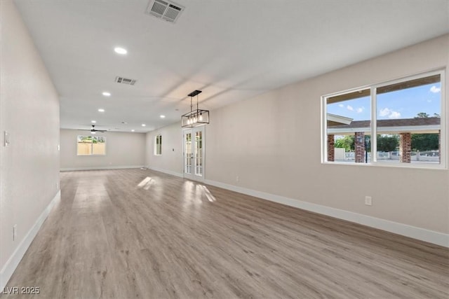 4805 Jay Ave, Las Vegas, NV 89130 - unfurnished living room featuring light wood finished floors, recessed lighting, plenty of natural light, and baseboards