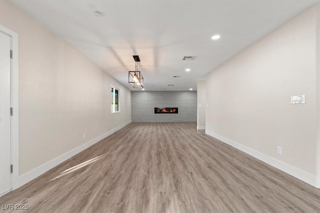 4805 Jay Ave, Las Vegas, NV 89130 - unfurnished living room with light wood-style floors, baseboards, recessed lighting, and a fireplace