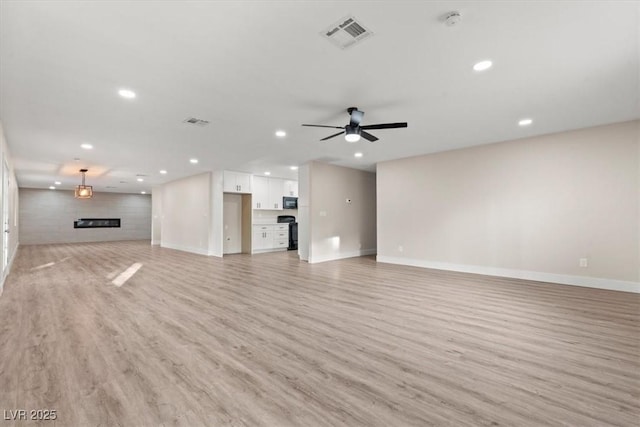 4805 Jay Ave, Las Vegas, NV 89130 - unfurnished living room with light wood-style floors, baseboards, ceiling fan, and recessed lighting