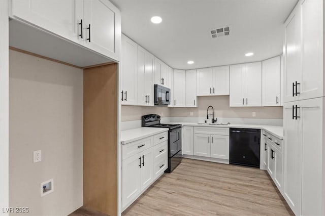 4805 Jay Ave, Las Vegas, NV 89130 - kitchen featuring black appliances, a sink, recessed lighting, white cabinets, and light countertops