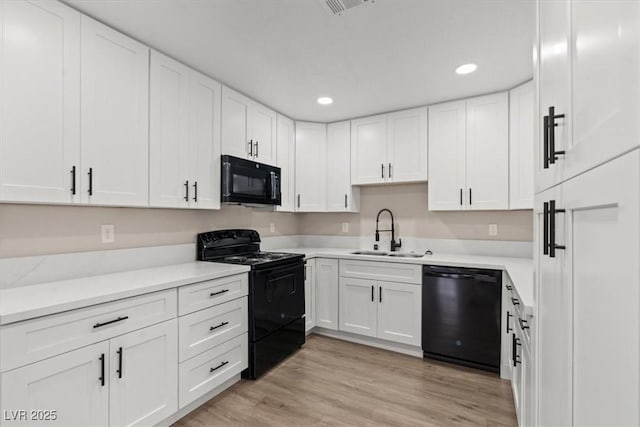 4805 Jay Ave, Las Vegas, NV 89130 - kitchen featuring black appliances, a sink, white cabinets, recessed lighting, and light countertops