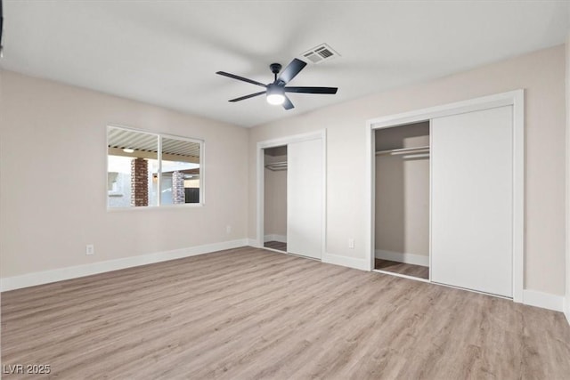 4805 Jay Ave, Las Vegas, NV 89130 - unfurnished bedroom featuring multiple closets, wood finished floors, baseboards, and ceiling fan