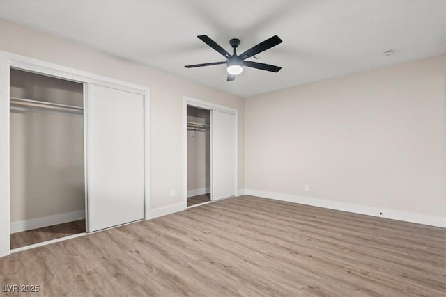 4805 Jay Ave, Las Vegas, NV 89130 - unfurnished bedroom featuring wood finished floors, two closets, baseboards, and a ceiling fan