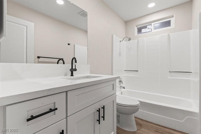 4805 Jay Ave, Las Vegas, NV 89130 - bathroom featuring toilet, vanity, wood finished floors, bathing tub / shower combination, and recessed lighting