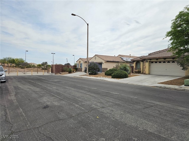 9462 Alhambra Valley St, Las Vegas, NV 89178 - view of asphalt road featuring sidewalks, street lights, and curbs