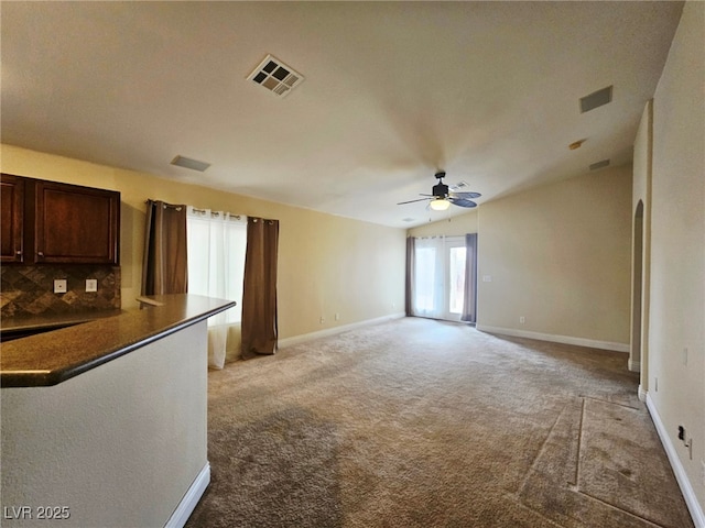 9462 Alhambra Valley St, Las Vegas, NV 89178 - unfurnished living room with ceiling fan, light colored carpet, and baseboards