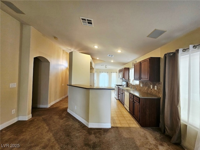 9462 Alhambra Valley St, Las Vegas, NV 89178 - kitchen featuring arched walkways, baseboards, dark brown cabinetry, dishwasher, and recessed lighting
