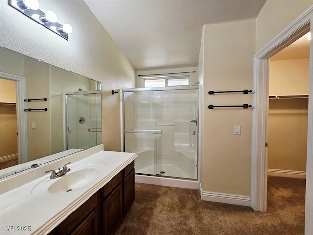 9462 Alhambra Valley St, Las Vegas, NV 89178 - full bathroom with a walk in closet, a stall shower, vanity, and baseboards