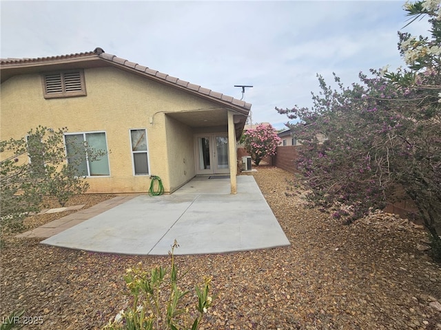 9462 Alhambra Valley St, Las Vegas, NV 89178 - back of property featuring french doors, stucco siding, a fenced backyard, central AC unit, and a patio