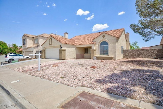 610 Playa Del Sol Way, Henderson, NV 89015 - mediterranean / spanish house with a tiled roof, stucco siding, a chimney, a garage, and concrete driveway