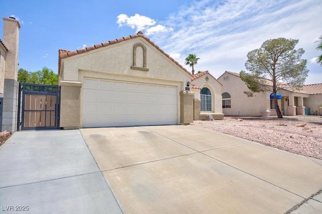 610 Playa Del Sol Way, Henderson, NV 89015 - mediterranean / spanish home with stucco siding, concrete driveway, a tiled roof, a gate, and an attached garage
