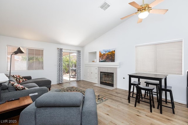 610 Playa Del Sol Way, Henderson, NV 89015 - living area featuring high vaulted ceiling, wood finished floors, a tiled fireplace, ceiling fan, and baseboards