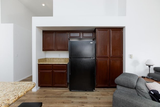 610 Playa Del Sol Way, Henderson, NV 89015 - kitchen featuring freestanding refrigerator, open floor plan, light wood-style floors, recessed lighting, and light stone counters