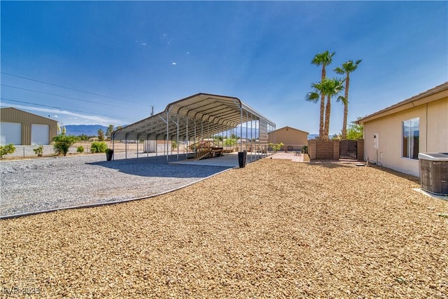 2851 Winchester Ave, Pahrump, NV 89048 - view of yard featuring a detached carport, driveway, and central AC unit