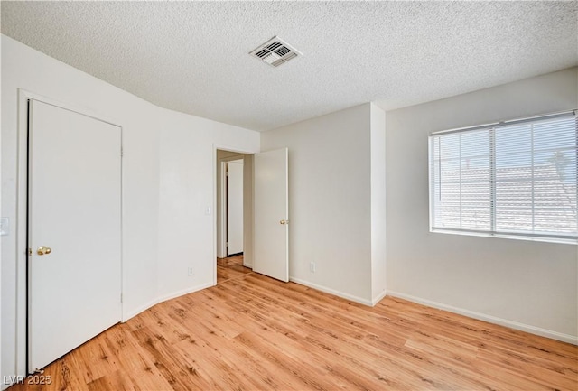 420 Clifton Heights Dr, Las Vegas, NV 89145 - unfurnished bedroom featuring wood finished floors, a textured ceiling, and baseboards