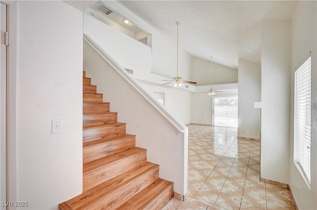 420 Clifton Heights Dr, Las Vegas, NV 89145 - staircase with vaulted ceiling, a ceiling fan, a textured ceiling, and baseboards