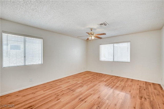 420 Clifton Heights Dr, Las Vegas, NV 89145 - unfurnished room with light wood-style floors, ceiling fan, baseboards, and a textured ceiling
