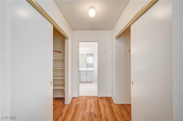 420 Clifton Heights Dr, Las Vegas, NV 89145 - corridor featuring a textured ceiling, light wood-style flooring, and baseboards