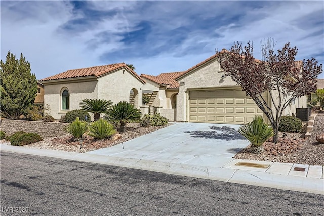2148 Shadow Canyon Dr, Henderson, NV 89044 - mediterranean / spanish house with a garage, a tiled roof, concrete driveway, stucco siding, and central AC