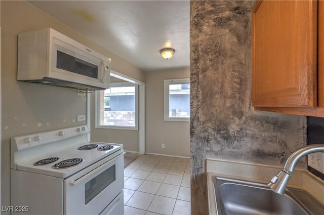 240 N 19th St, Las Vegas, NV 89101 - kitchen featuring white appliances, a sink, baseboards, and light tile patterned flooring