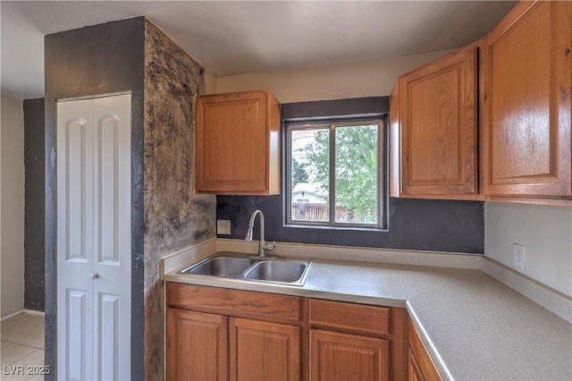 240 N 19th St, Las Vegas, NV 89101 - kitchen with a sink, brown cabinets, and light countertops