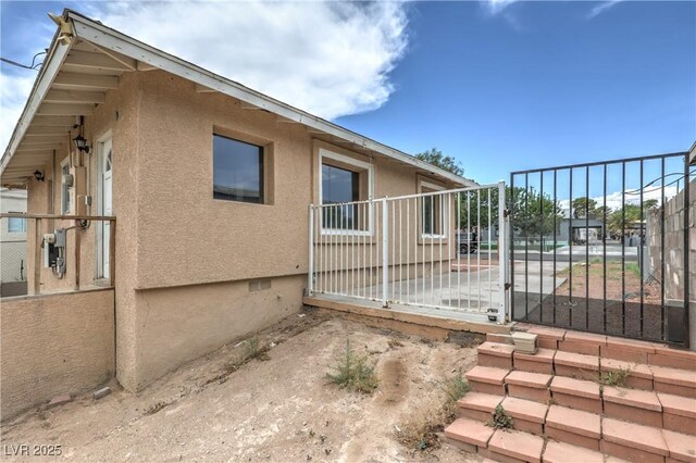 240 N 19th St, Las Vegas, NV 89101 - view of side of property featuring stucco siding and a gate