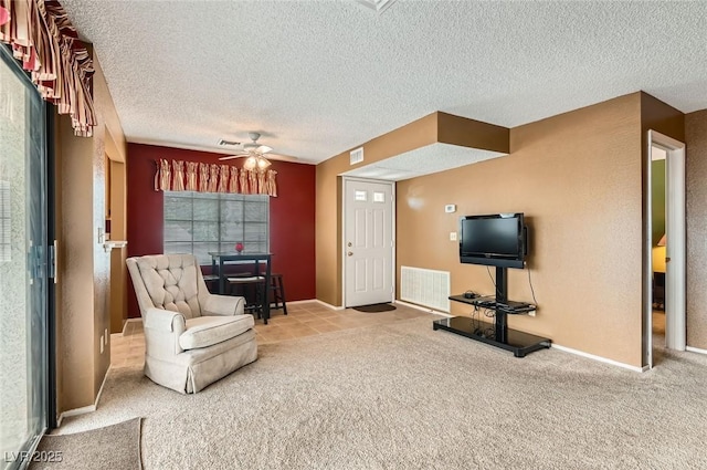 4718 Nara Vista Way Unit 104, Las Vegas, NV 89103 - sitting room with a textured ceiling, carpet floors, a ceiling fan, and baseboards