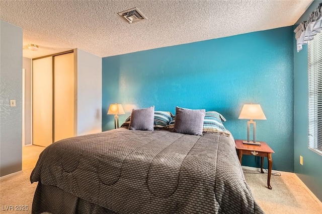 4718 Nara Vista Way Unit 104, Las Vegas, NV 89103 - bedroom with carpet flooring, a closet, and a textured ceiling