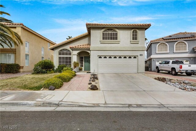 2418 Antler Point Dr, Henderson, NV 89074 - mediterranean / spanish house with a garage, stucco siding, concrete driveway, and a tiled roof