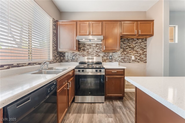 28 Yellow Flame Ave, North Las Vegas, NV 89084 - kitchen featuring gas range, black dishwasher, under cabinet range hood, a sink, and light wood-type flooring