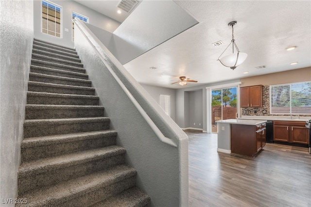 28 Yellow Flame Ave, North Las Vegas, NV 89084 - stairs featuring wood finished floors, healthy amount of natural light, recessed lighting, a ceiling fan, and baseboards