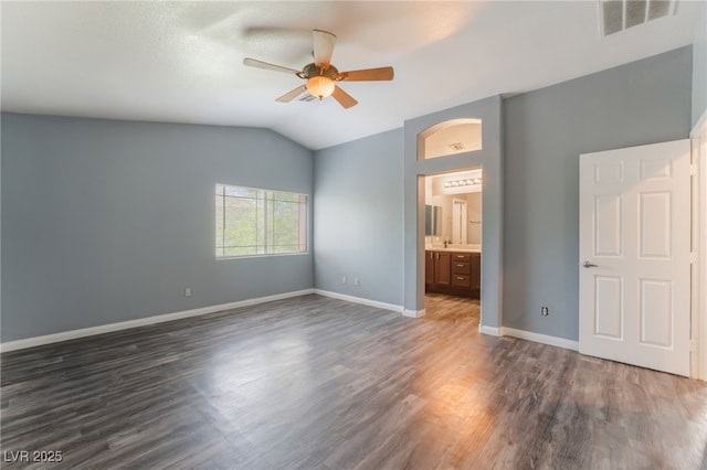28 Yellow Flame Ave, North Las Vegas, NV 89084 - unfurnished bedroom with vaulted ceiling, dark wood finished floors, baseboards, arched walkways, and ceiling fan