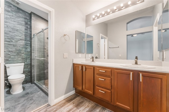 28 Yellow Flame Ave, North Las Vegas, NV 89084 - bathroom with toilet, double vanity, a shower stall, and wood finished floors