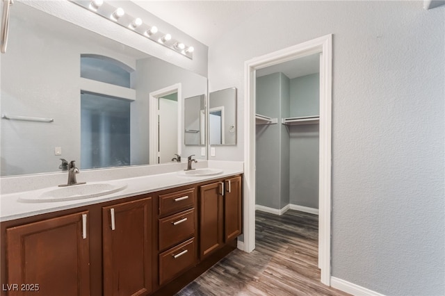 28 Yellow Flame Ave, North Las Vegas, NV 89084 - bathroom with double vanity, wood finished floors, and baseboards