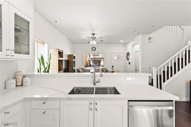 9613 Eland Ct, Las Vegas, NV 89149 - kitchen with stainless steel dishwasher, a sink, a ceiling fan, open floor plan, and white cabinets