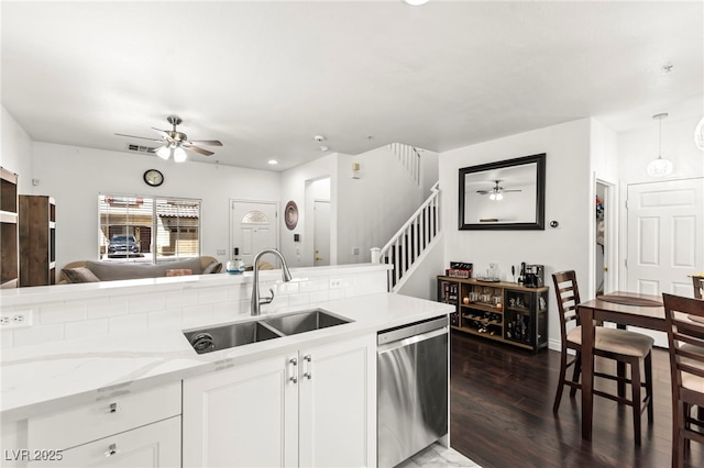 9613 Eland Ct, Las Vegas, NV 89149 - kitchen with stainless steel dishwasher, ceiling fan, a sink, dark wood-style flooring, and recessed lighting