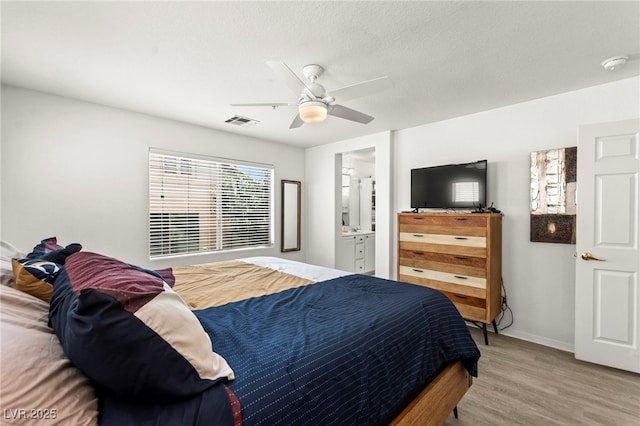 9613 Eland Ct, Las Vegas, NV 89149 - bedroom featuring wood finished floors, baseboards, ceiling fan, and connected bathroom