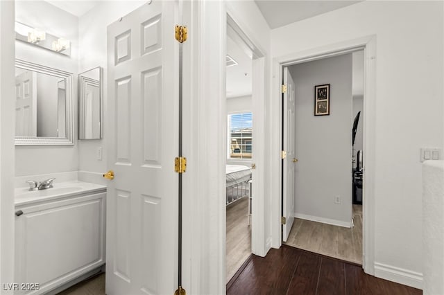 9613 Eland Ct, Las Vegas, NV 89149 - bathroom featuring vanity, wood finished floors, and baseboards