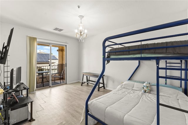9613 Eland Ct, Las Vegas, NV 89149 - bedroom with a chandelier, access to exterior, wood finished floors, and baseboards