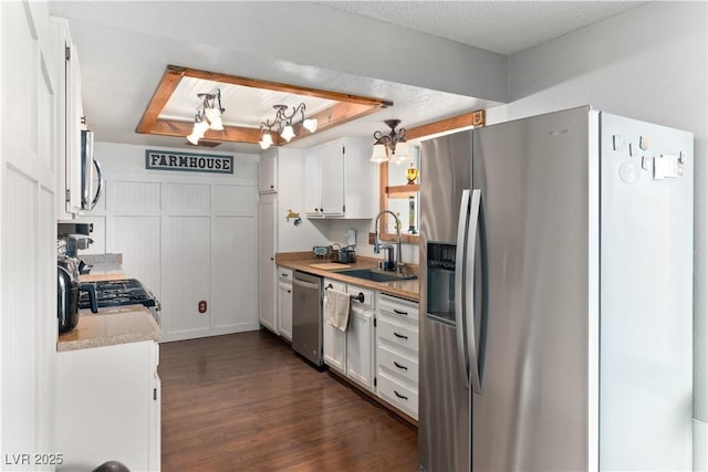 3008 Soledad Dr, Laughlin, NV 89029 - kitchen featuring appliances with stainless steel finishes, white cabinetry, dark wood-style flooring, a sink, and light countertops
