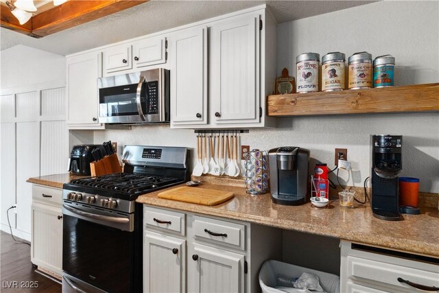 3008 Soledad Dr, Laughlin, NV 89029 - kitchen featuring appliances with stainless steel finishes, light countertops, white cabinetry, and dark wood-style floors