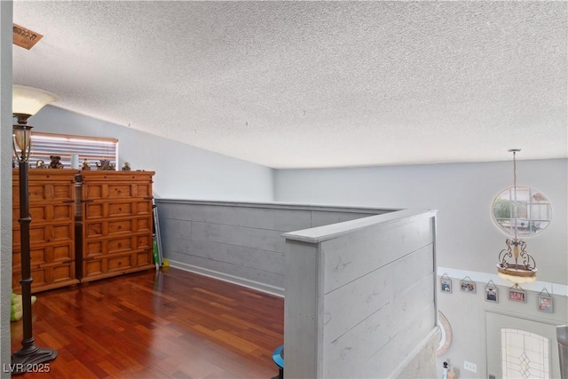 3008 Soledad Dr, Laughlin, NV 89029 - corridor featuring a textured ceiling, dark wood-style floors, and plenty of natural light