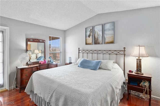 3008 Soledad Dr, Laughlin, NV 89029 - bedroom featuring wood finished floors, vaulted ceiling, baseboards, a textured ceiling, and a textured wall